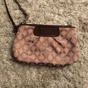 Coach wristlet Never used. A rose gold-like color